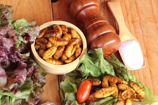 Silkworm pupae on wood background