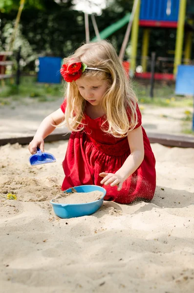 Girl playing in sandpit