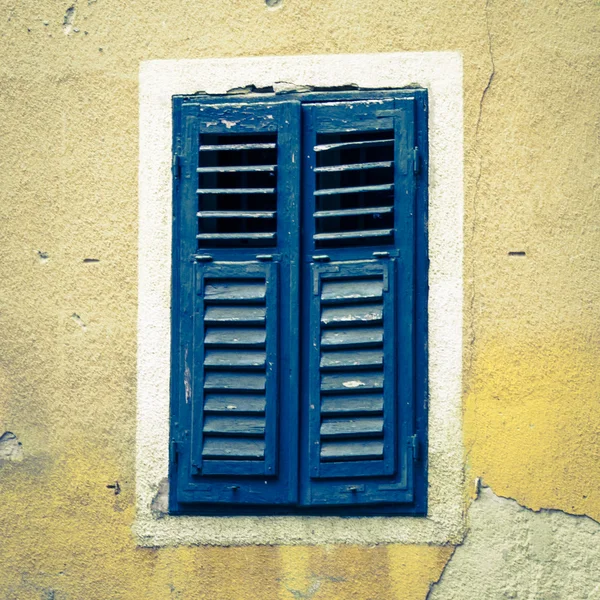 Blue shutter closed window