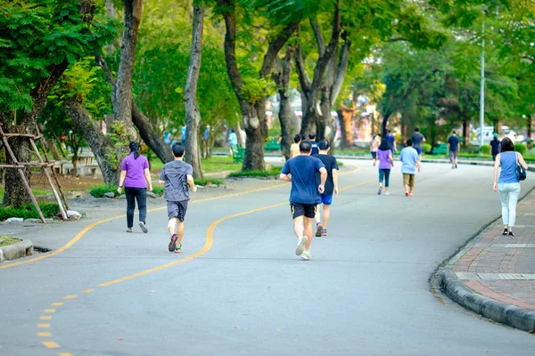 Jogging man running in public park