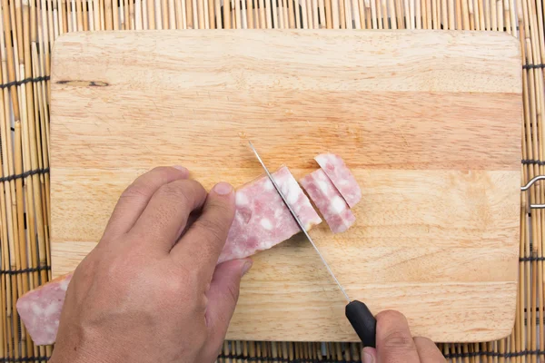 Chef cutting bacon for cooking fired rice