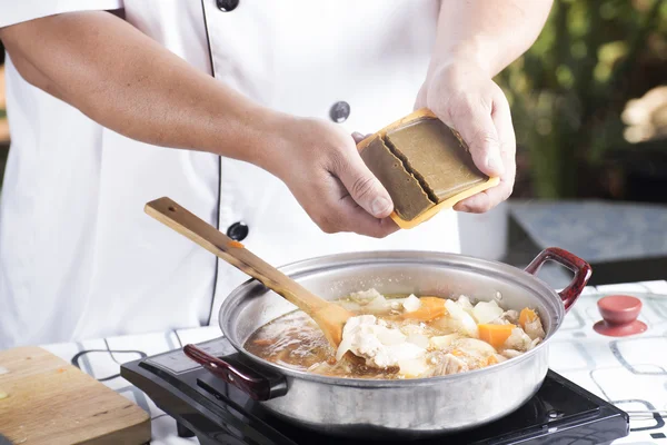 Chef putting Japanese curry paste for cooking