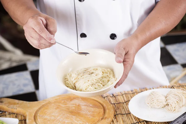 Chef cooking Noodle with seasoning sauce