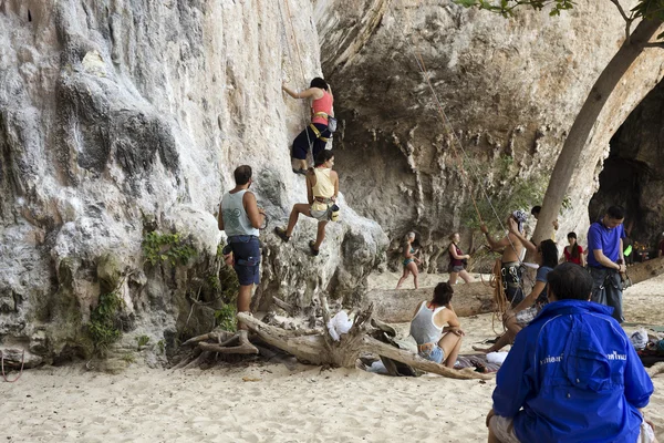 Rock climbers climbing the wall on Phra Nang beach