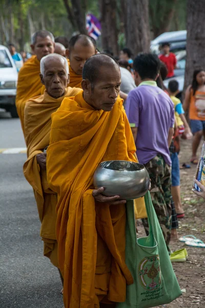 Prachuap Khiri Khan, THAILAND - APRIL 13 : Buddhist monks are given food offering from people for Songkran day or Thai New Year Festival . on April 13, 2016 in Prachuap Khiri Khan, Thailand.