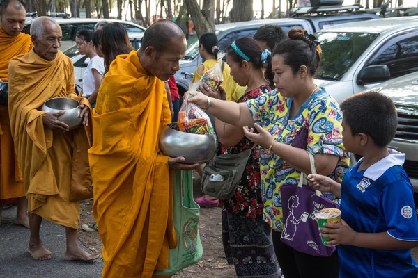 Prachuap Khiri Khan, THAILAND - APRIL 13 : Buddhist monks are given food offering from people for Songkran day or Thai New Year Festival . on April 13, 2016 in Prachuap Khiri Khan, Thailand.