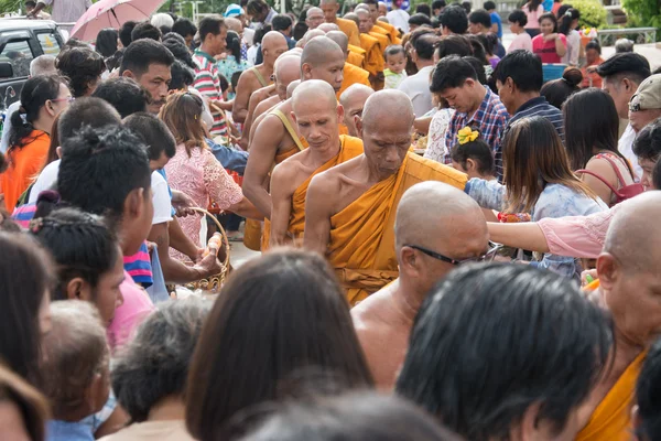 Samutprakarn, THAILAND - OCT 09 : Buddhist monks are given food offering from people for End of Buddhist Lent Day. on October 09, 2014 inSamutprakarn, Thailand.