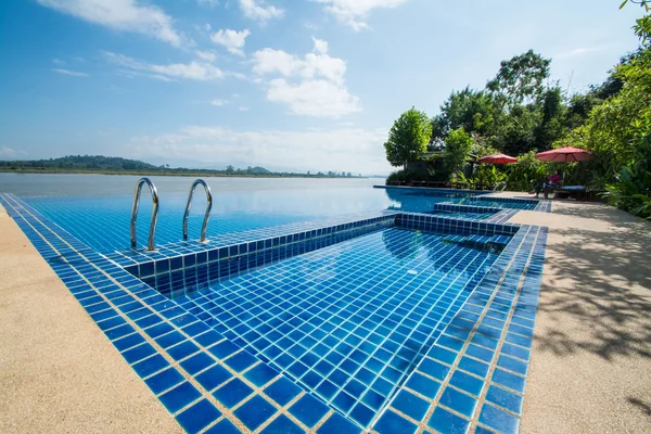 Swimming pool near Khong river with blue sky ,Chiangsan in Chiangrai ,Thailand