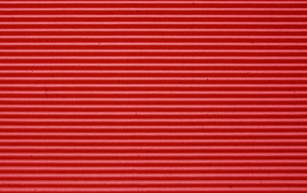Red corrugated paper background.