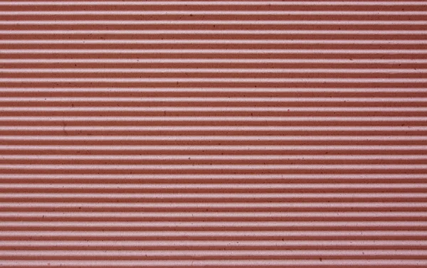Red corrugated paper background.