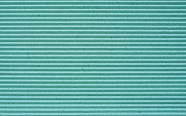 Green corrugated paper background.
