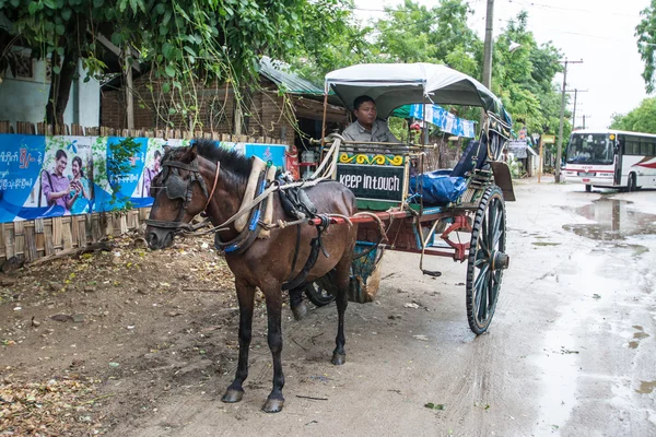 BAGAN,MYANMAR-JULY 30,2015 : Unidentified carriage of passengers and carrying supplies the local road runs along to a village on July 30,2015 in Bagan ancient city,Mandalay State in Middle of Myanmar.