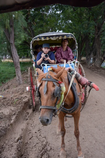 INWA,MYANMAR-JULY 31,2015 : Unidentified carriage of passengers and carrying supplies the local road runs along to a village on July 31,2015 in Inwa ancient city,Mandalay State in Middle of Myanmar.