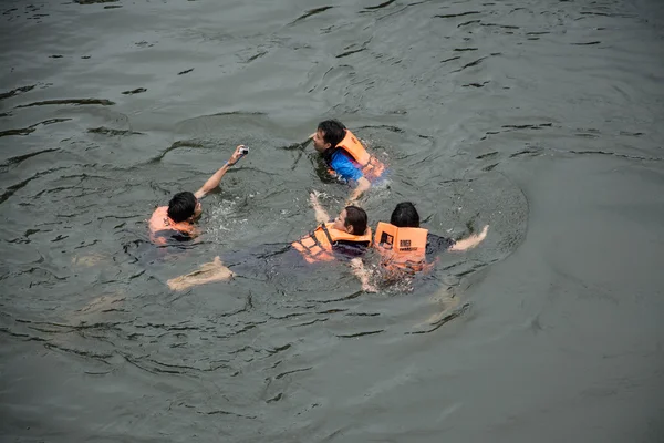 KANCHANABURI PROVINCE, THAILAND - SEPTEMBER 13: people swimming in river Kwai. Taken at Sai Yok Yai waterfall. Kanchanaburi of Thailand. on September 13, 2015.