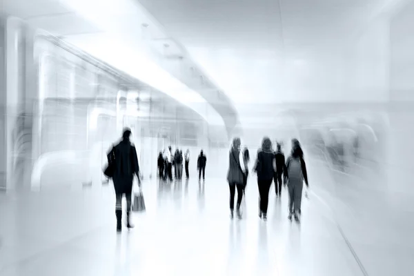 Group of people in the lobby business center and blue tonality