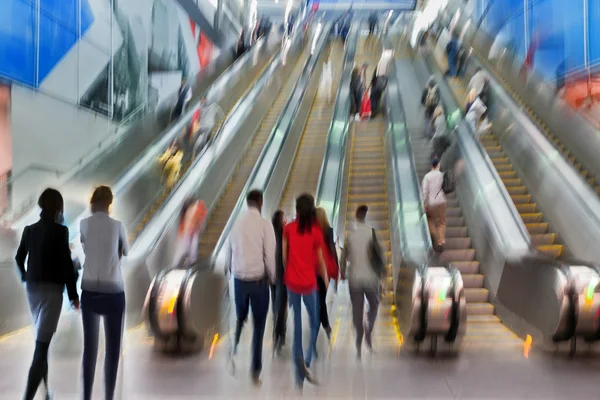 People on moving escalator motion blur