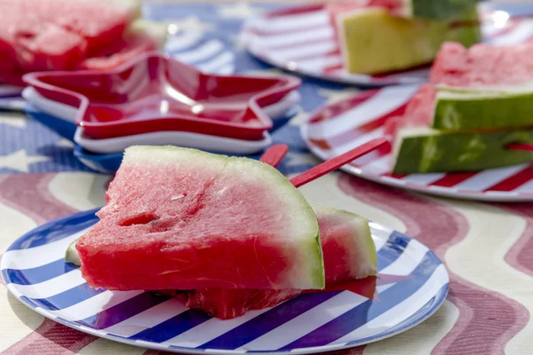 Watermelon on a stick at picnic