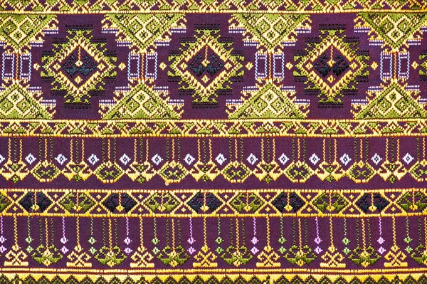 Colorful thai silk handcraft peruvian style rug surface old vintage torn conservation Made from natural materials Chemical free close up silk background silk texture