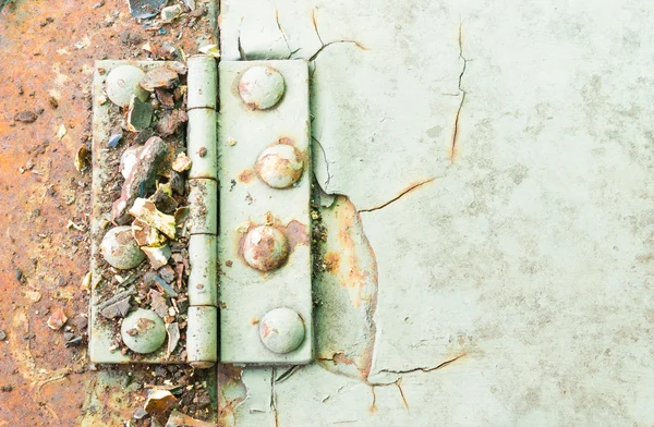 Hinge and Rust and Rivet on Old Light Green Metal Sheet of Car Part