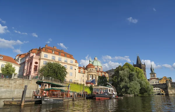 Boats docked at riverside of Vltava River, Prague, Czech Republic