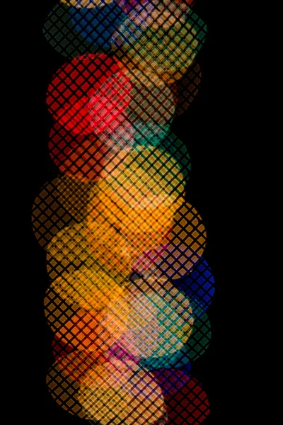Bokeh in the form of colored circles on a black background