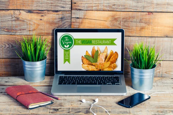 Vegan restaurant website in a laptop computer. Workplace stuff.