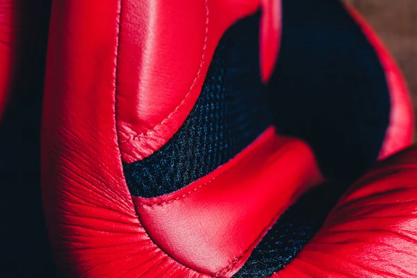 Macro detail of red boxing gloves.