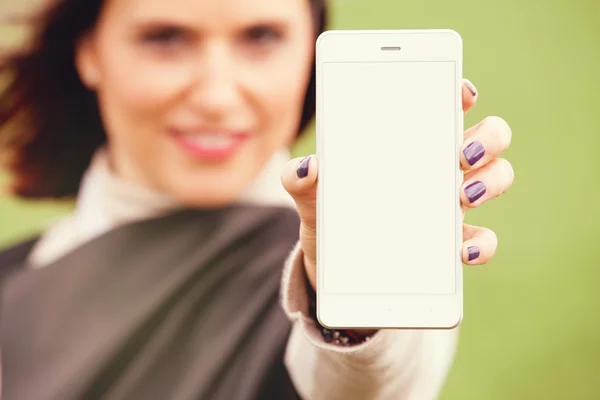 Woman showing mobile phone screen to the camera.