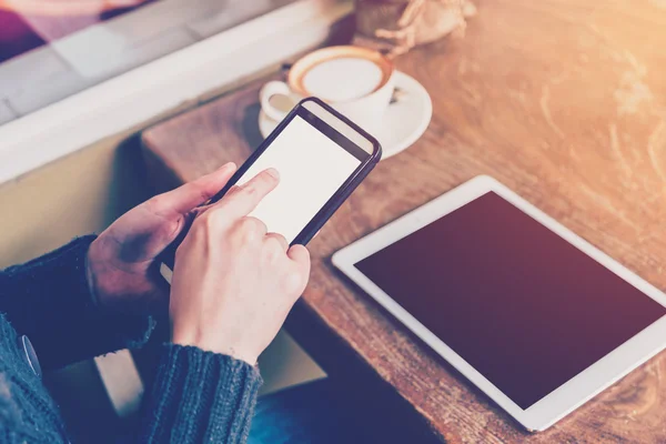 Hand woman using smartphone in coffee shop and soft light