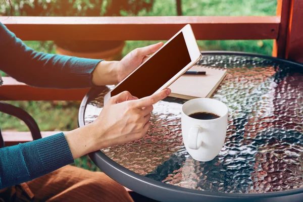 Asian woman using tablet on table and coffee in garden with vint