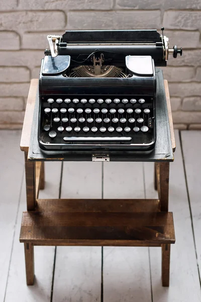 Antique typewriter. Vintage typewriter machine closeup retro styled.