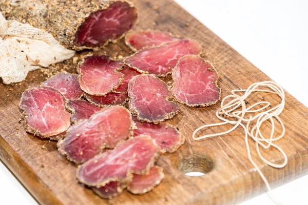 Various sliced meats on wooden serving board. Ham, pork or beef. Preparing for dinner. Selective focus.