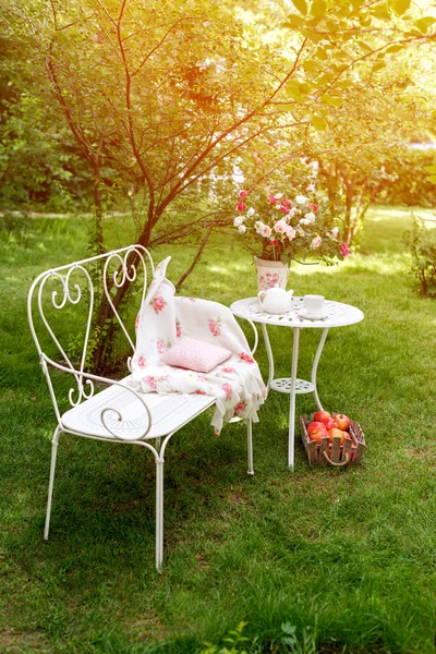 Summer garden with tea party setting. Outdoor decorations.