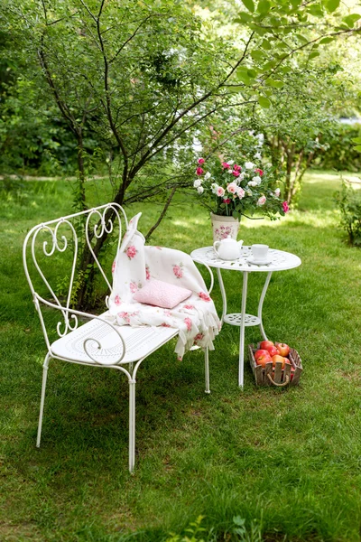 Summer garden with tea party setting. Outdoor decorations.