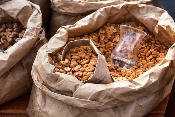 Salted peanuts in a paper bag closeup. Street food.