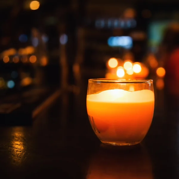 Candle in a glass. Photos of cafe or restaurant reception. Selective focus with bokeh