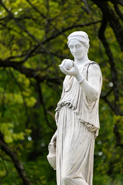 Marble statue of the Greek goddess Hera or the Roman goddess Juno, holding an apple of discord in the park of the Palace and park complex Estate of G. Galagan. Sokyryntsi village, Ukraine.