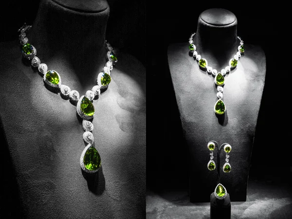 Set of luxury jewelry made of white gold with diamonds and emeralds on a stand.