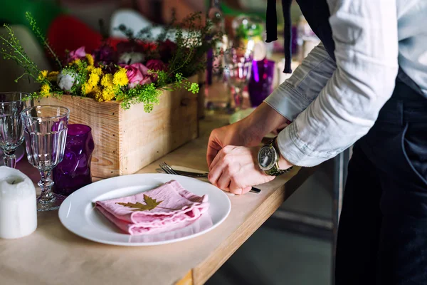 Cropped image of girl decorating dinner table. Cooking, profession, food and people concept - closeup of chef cook decorating dishes.