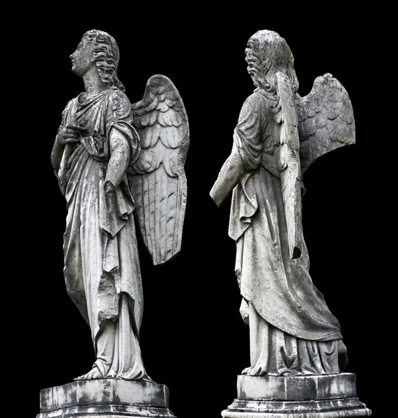 Old tombstone sculptures of an angel with broken arm and wings isolated on black.