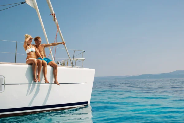 Couple in love on a sail boat in the summer.