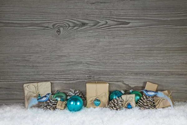 Grey wooden christmas background with turquoise decoration and g