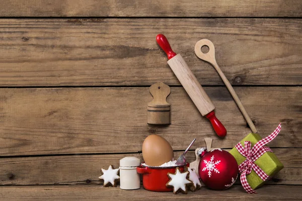 Baking in christmas time. Wooden background with kitchen utensil