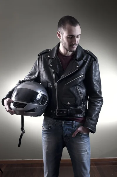 Biker in leather jacket and helmet