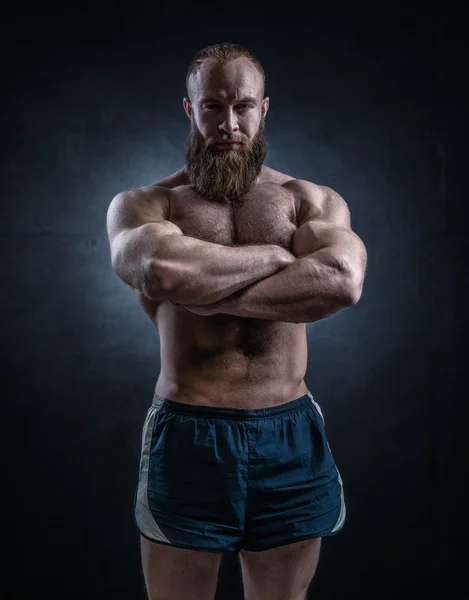 Strong bearded man with perfect abs, shoulders, biceps, triceps
