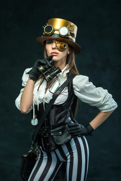 Portrait of a beautiful steampunk girl with binoculars