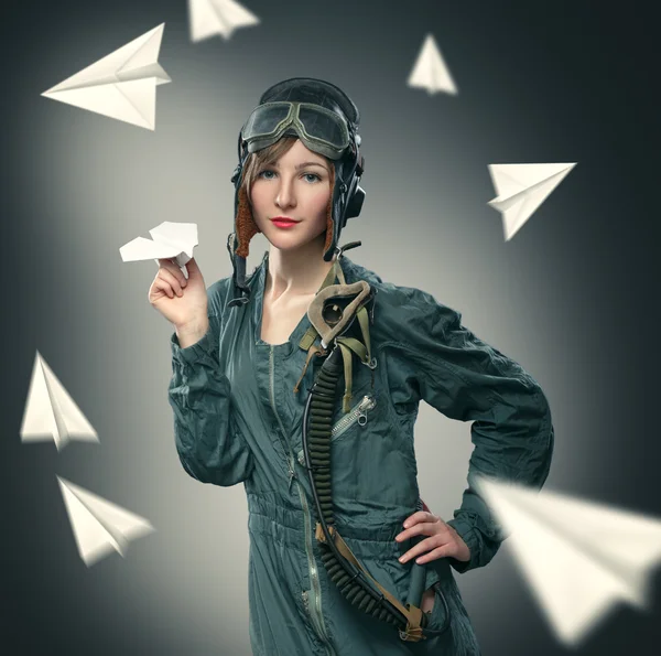 Woman pilot, playing with paper airplanes