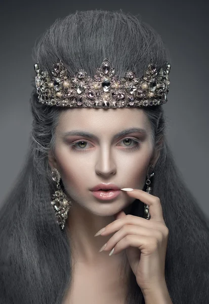 Portrait of a beautiful woman in the diamond crown and earrings