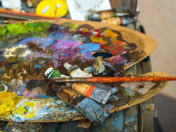 Tubes of paint on a palette for mixing oil paints