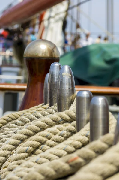 Mooring rope tied on the bollards of old wooden ship